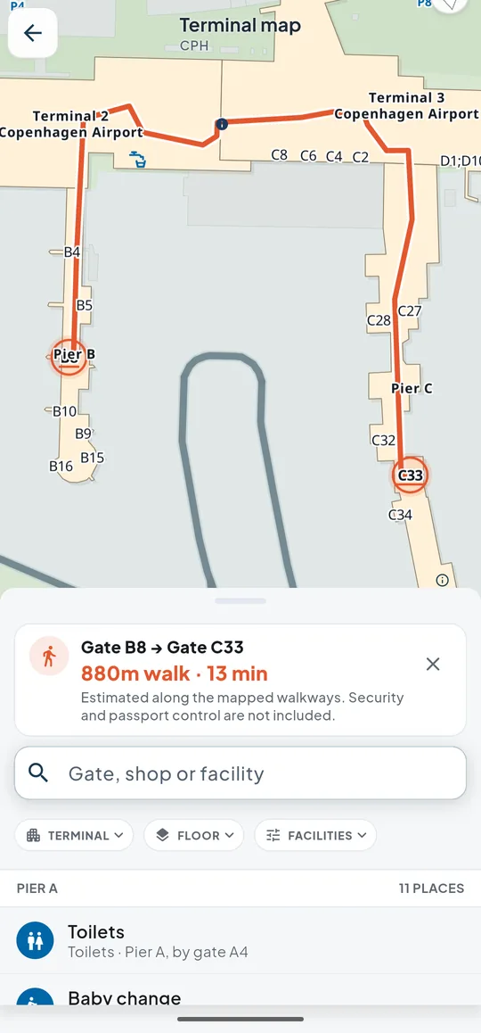 The Copenhagen terminal map on Android with the walk from gate B8 to gate C33 drawn on it: 880 metres, 13 minutes along mapped walkways